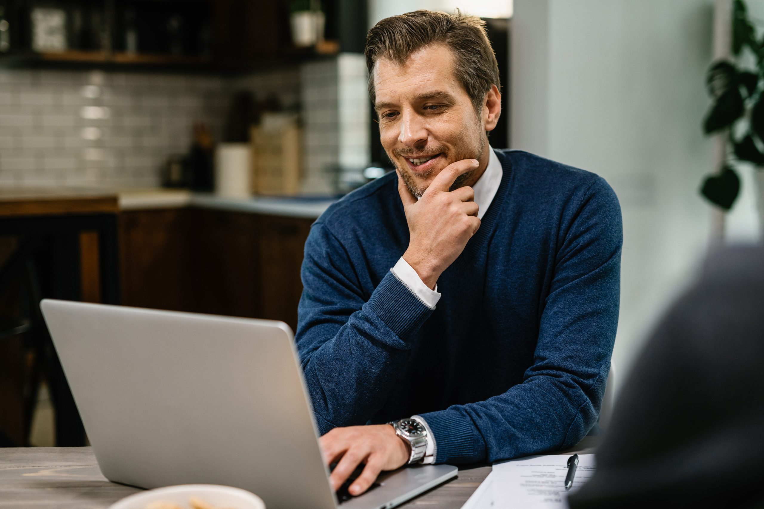 Happy financial advisor working on a laptop