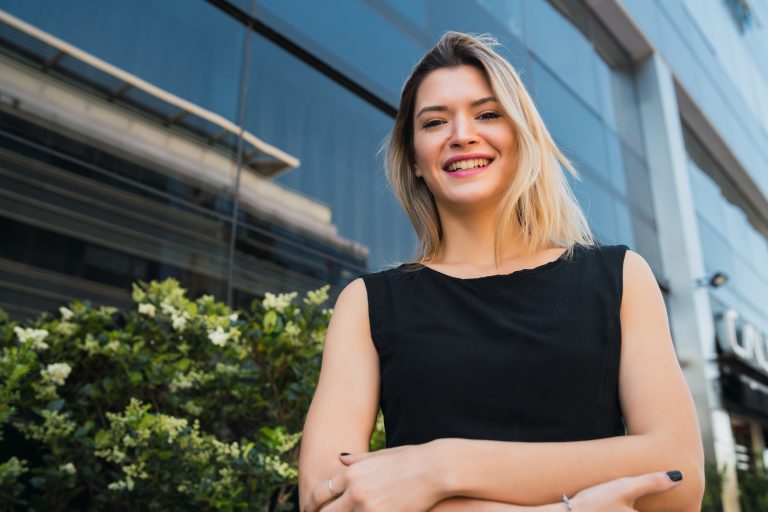 Business woman standing outside office buildings