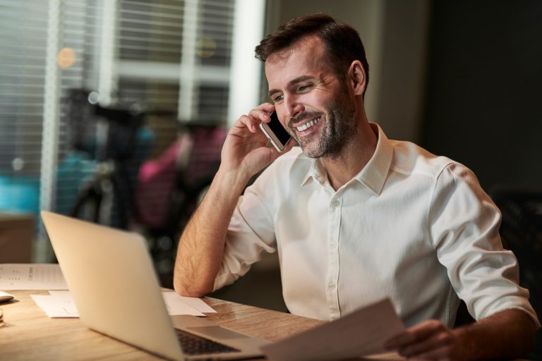 smiling-businessman-talking-by-mobile-phone